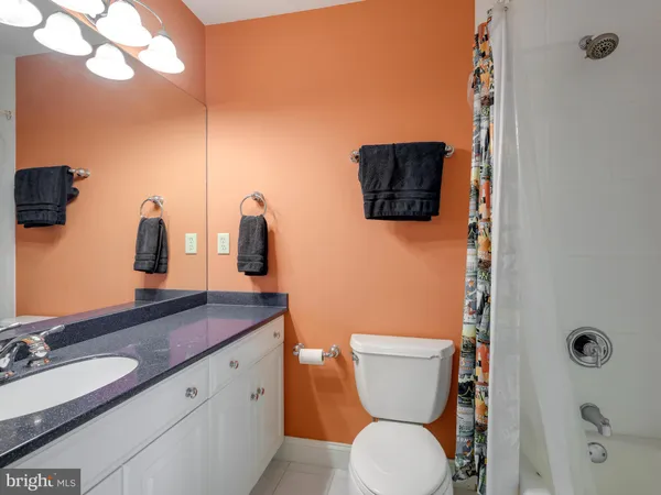 a view of a big house with a big yard and large trees