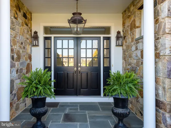 a living room with furniture large window and a fireplace