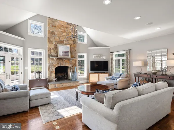 a living room with furniture and floor to ceiling windows