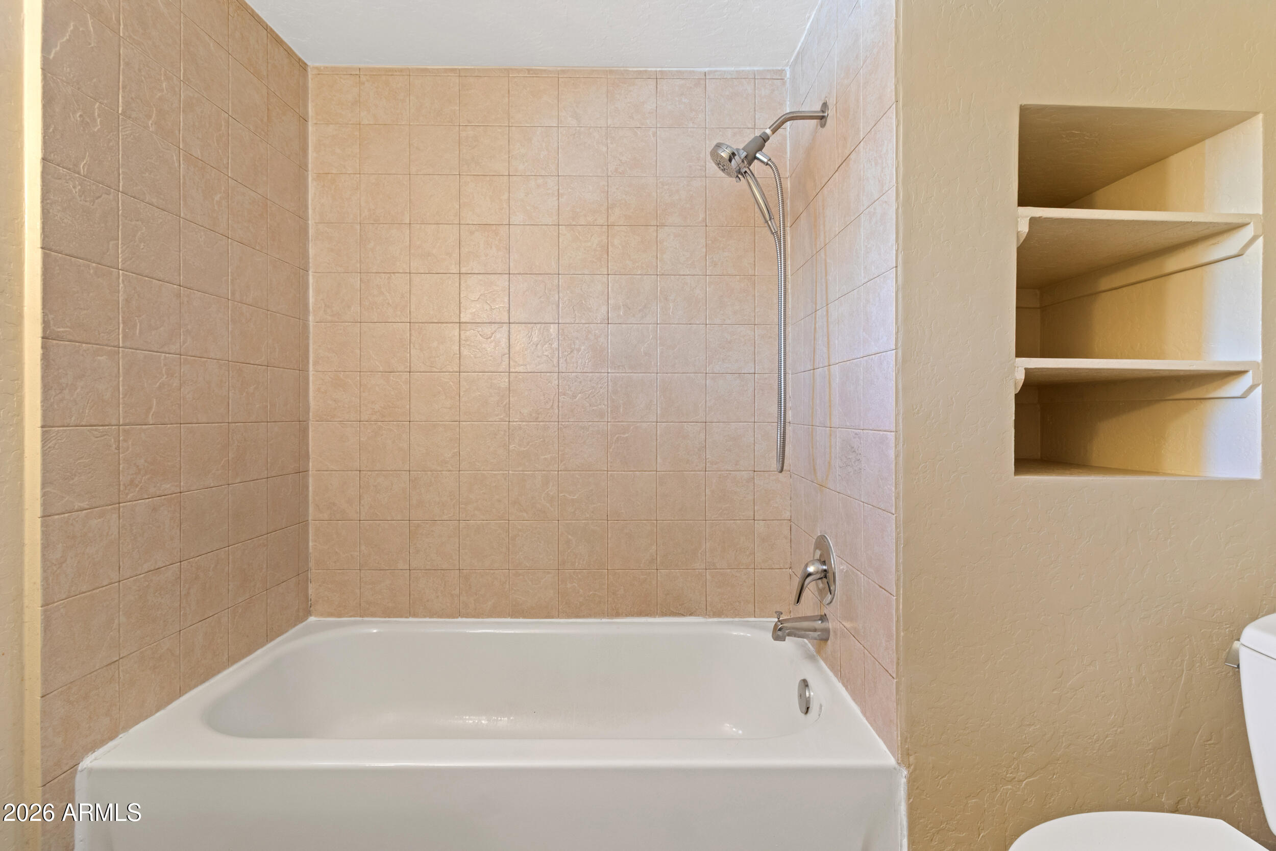 535 South Alma School Road, Unit 69 Mesa, AZ 85210 - Photo 14 of 59 a white bath tub sitting next to a white sink and vanity