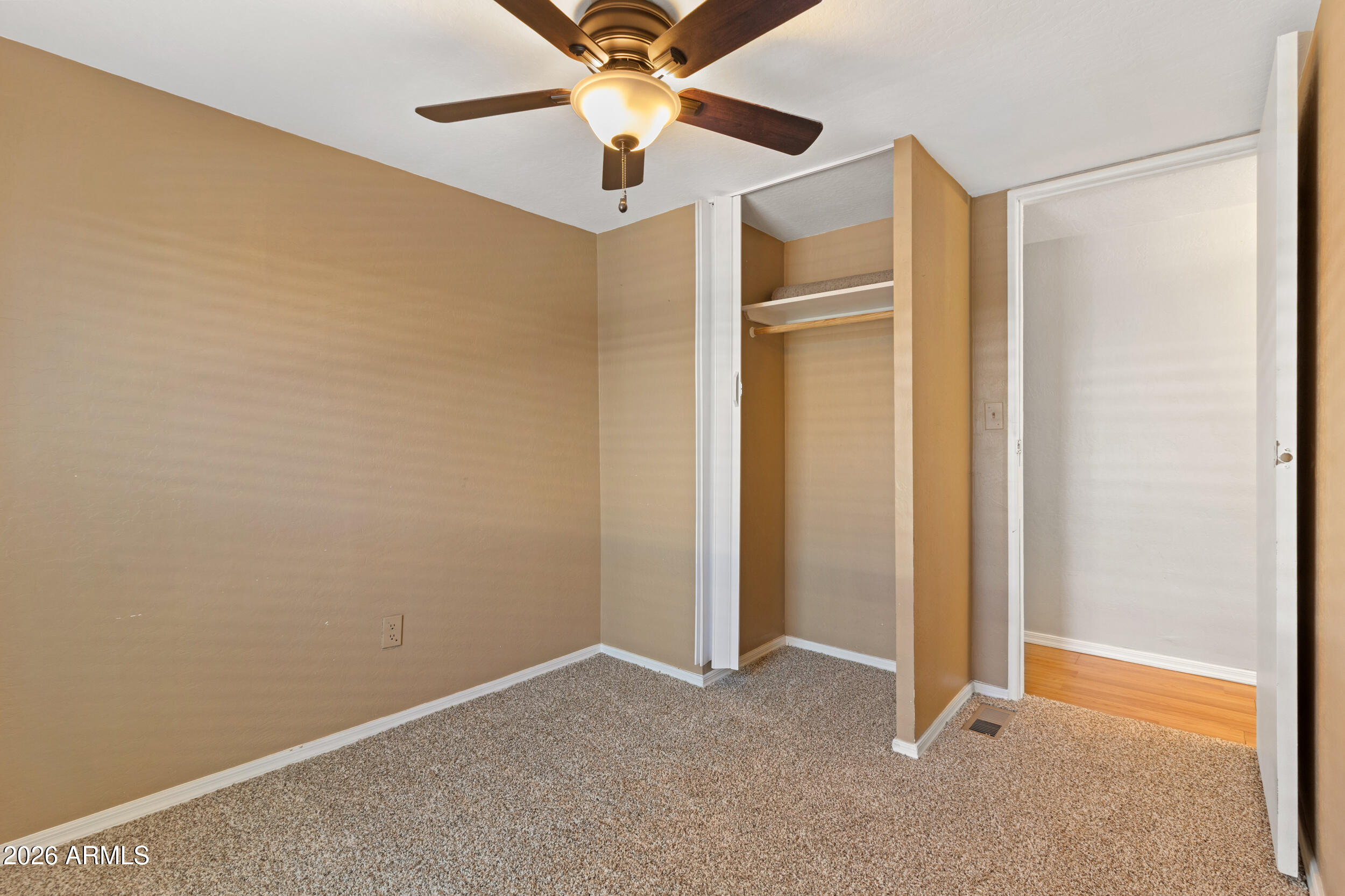 535 South Alma School Road, Unit 69 Mesa, AZ 85210 - Photo 15 of 59 an empty room with closet and a chandelier fan