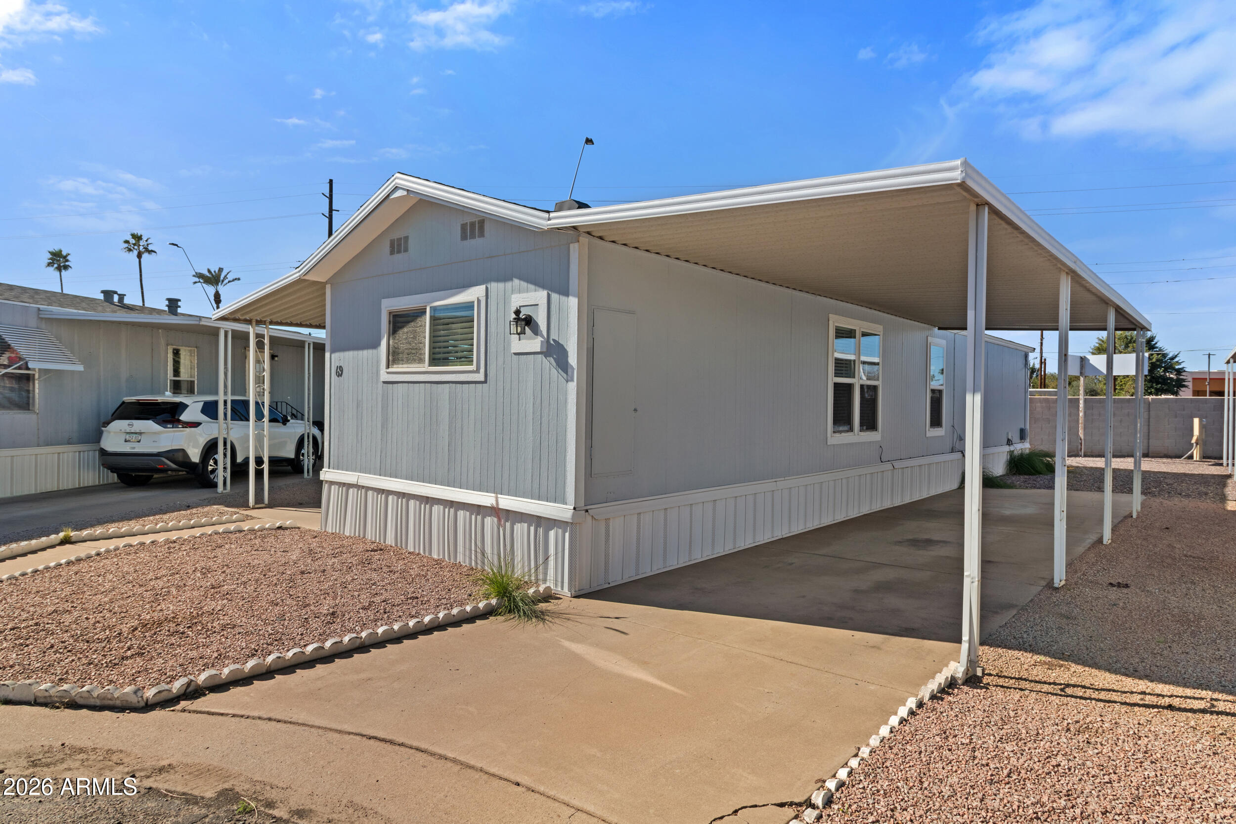 535 South Alma School Road, Unit 69 Mesa, AZ 85210 - Photo 20 of 59 a front view of a house with garden