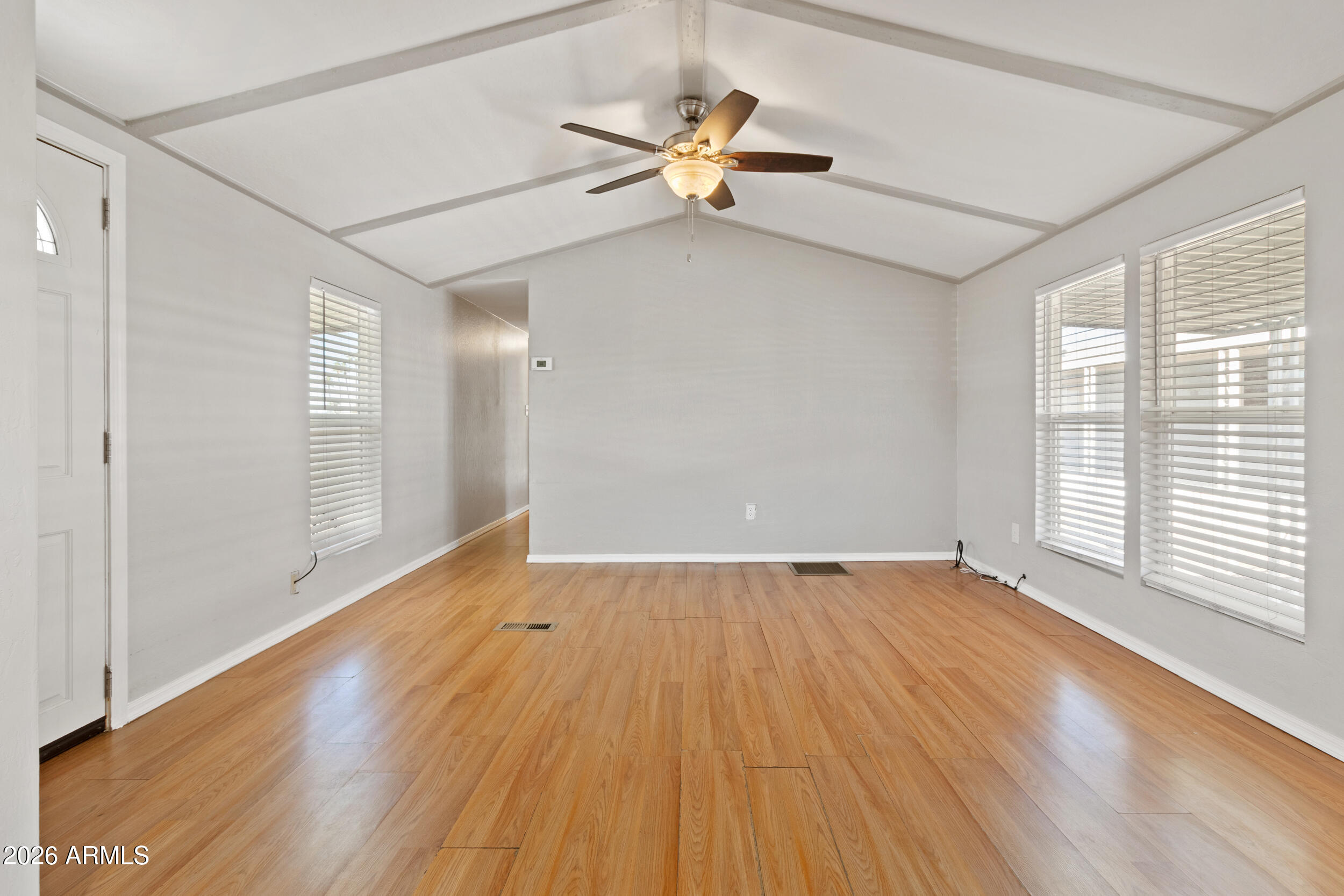 535 South Alma School Road, Unit 69 Mesa, AZ 85210 - Photo 2 of 59 a view of an empty room with a window and wooden floor