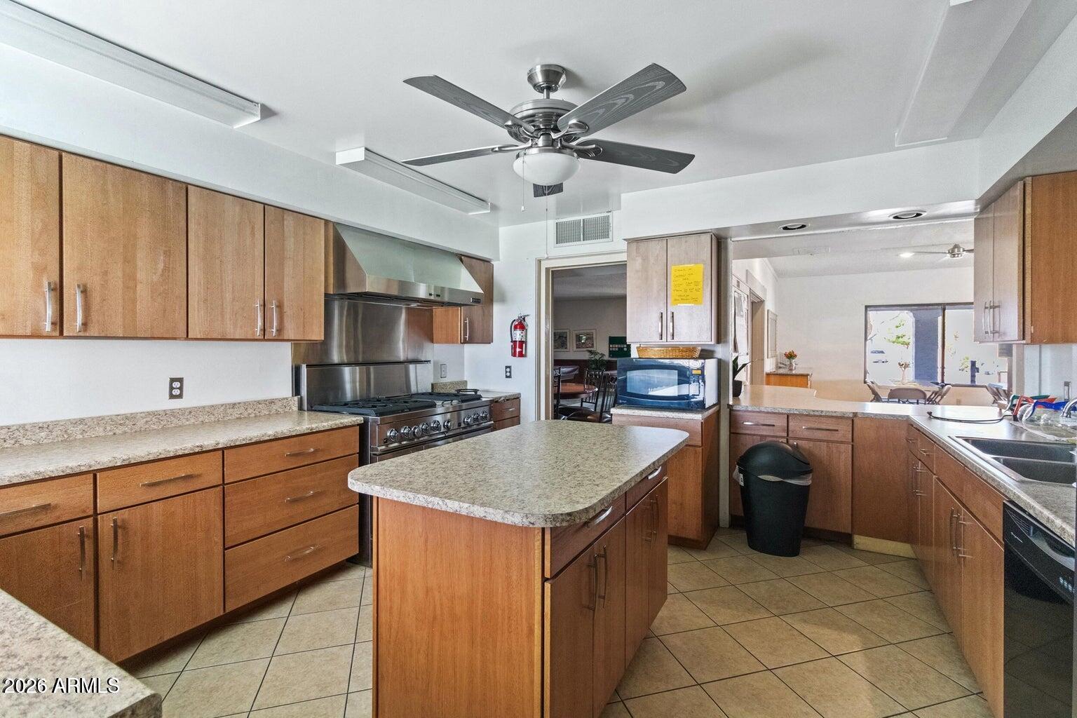 535 South Alma School Road, Unit 69 Mesa, AZ 85210 - Photo 29 of 59 a kitchen with stainless steel appliances granite countertop a sink counter space cabinets and a stove