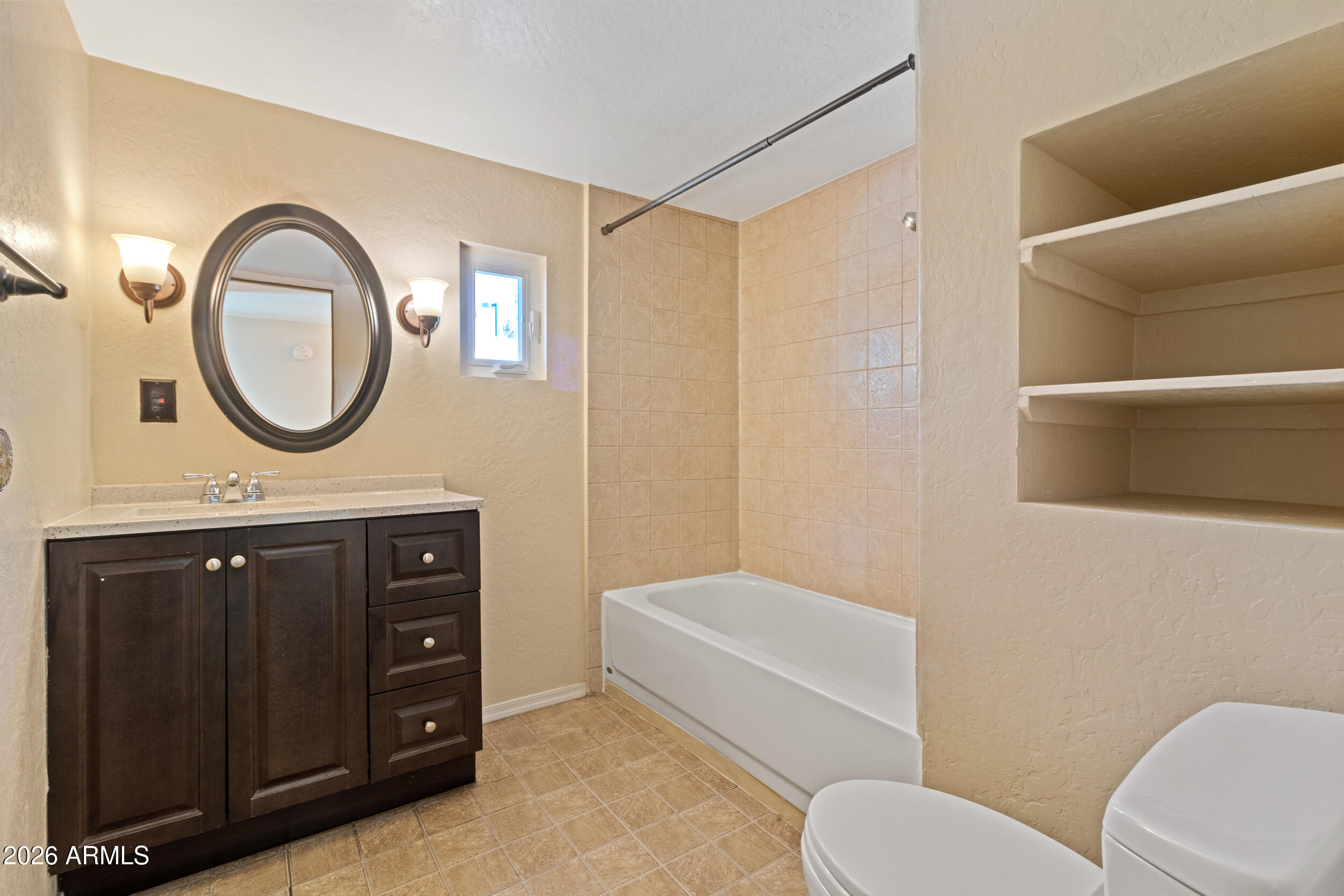 535 South Alma School Road, Unit 69 Mesa, AZ 85210 - Photo 4 of 59 a bathroom with a toilet a sink and a mirror