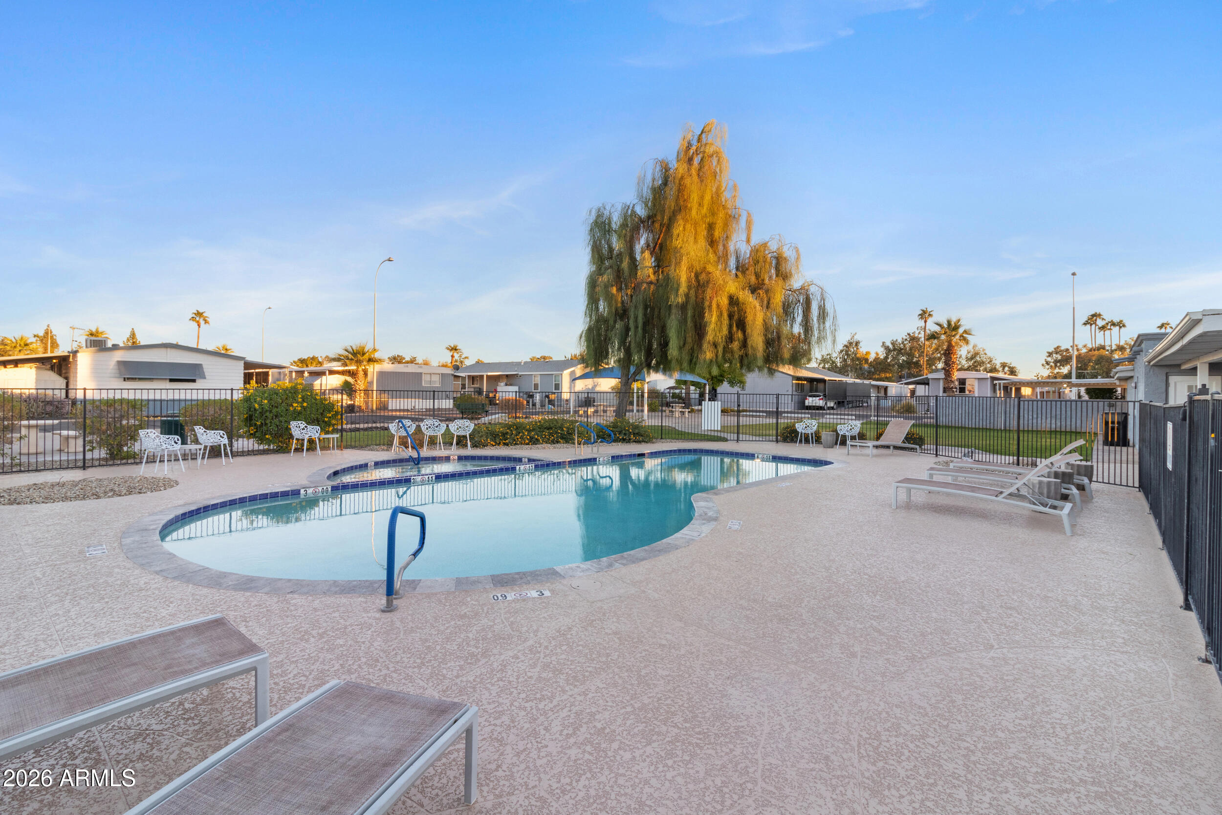 535 South Alma School Road, Unit 69 Mesa, AZ 85210 - Photo 41 of 59 a swimming pool with outdoor seating and yard