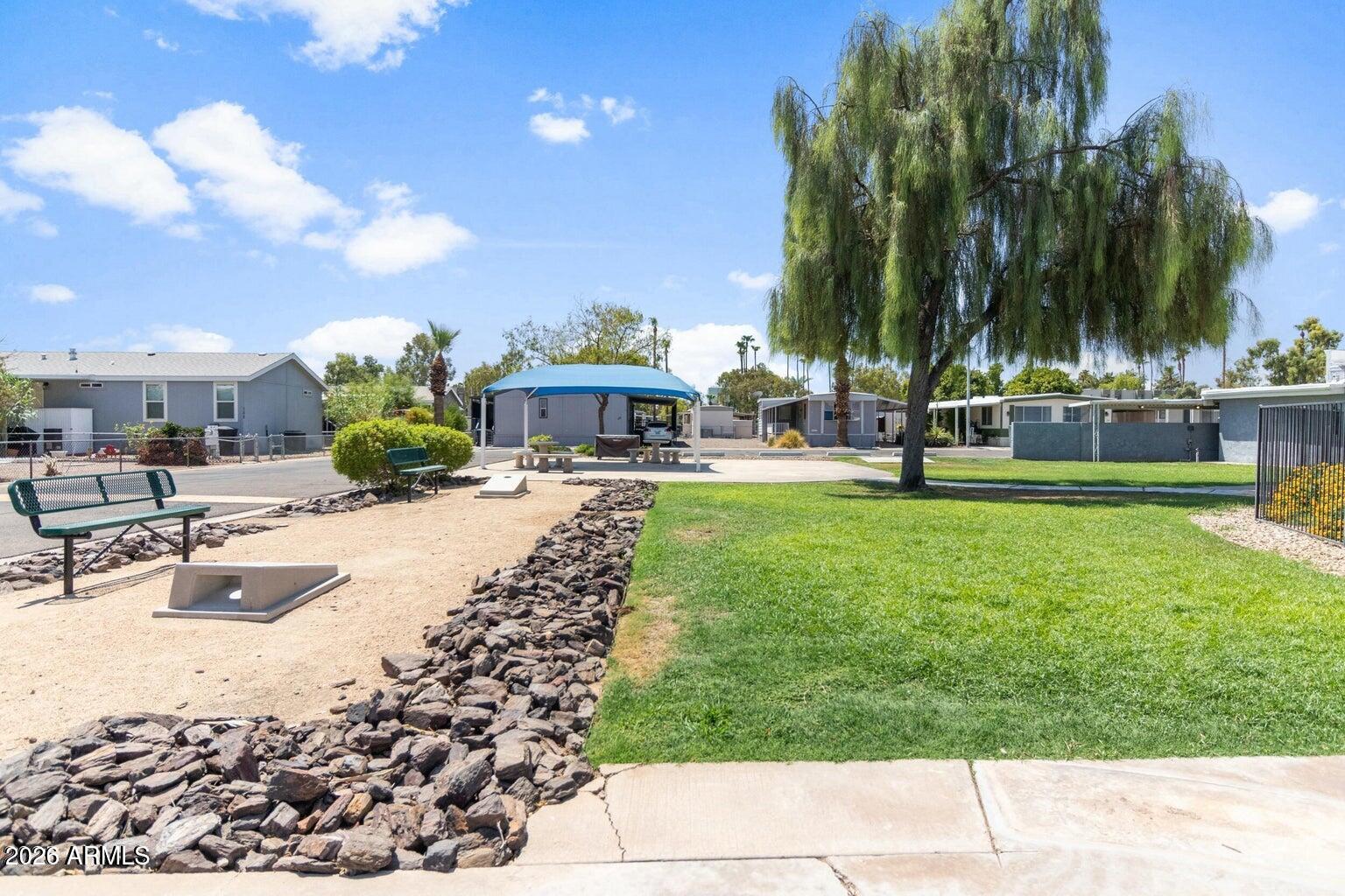 535 South Alma School Road, Unit 69 Mesa, AZ 85210 - Photo 44 of 59 a swimming pool with outdoor seating and yard