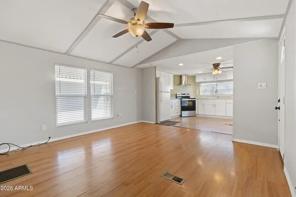 a kitchen with granite countertop a refrigerator stove top oven and sink