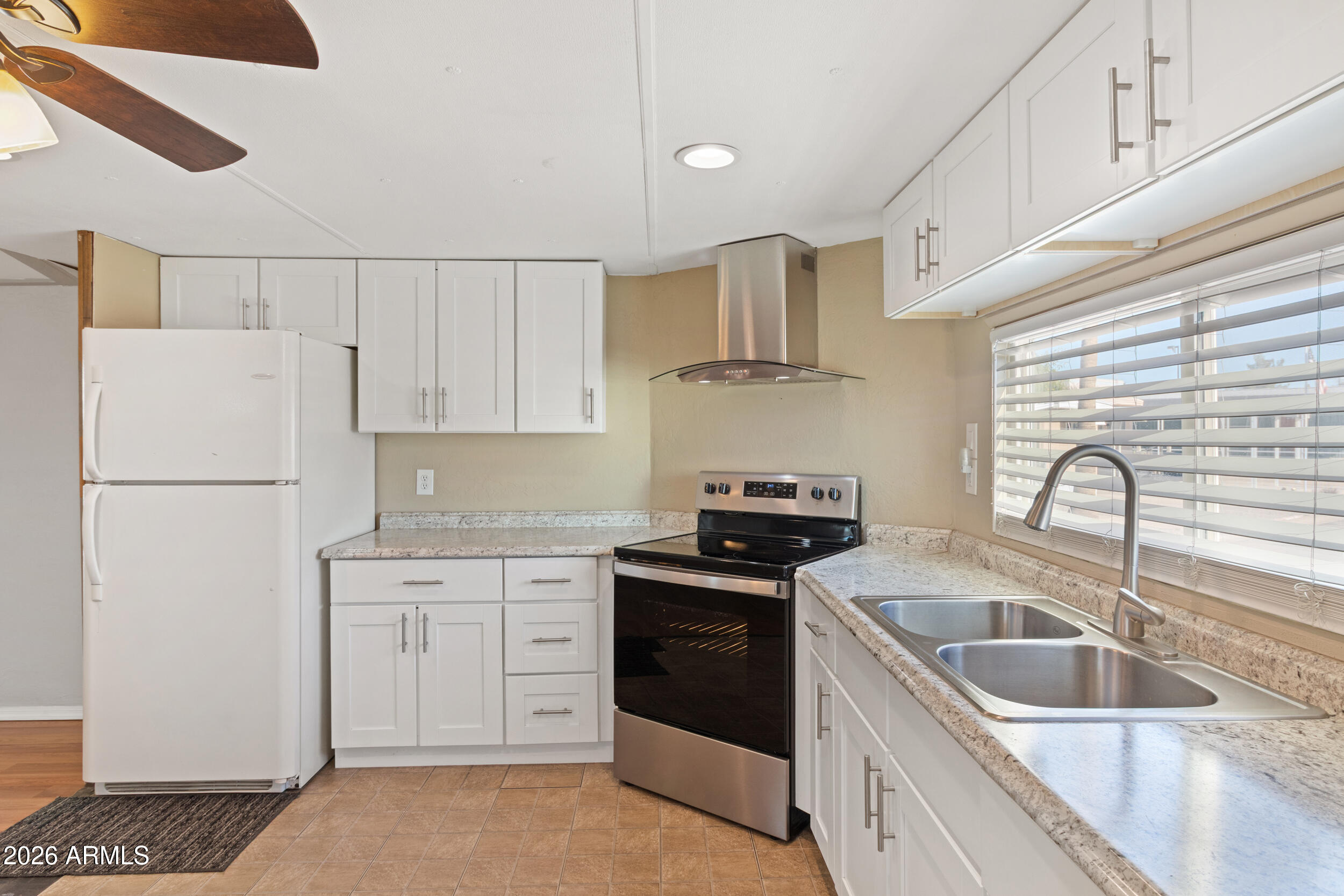 535 South Alma School Road, Unit 69 Mesa, AZ 85210 - Photo 10 of 59 a kitchen with appliances a sink and cabinets