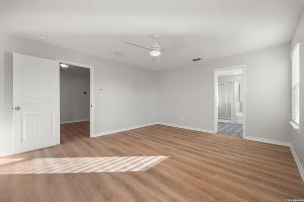 a view of an empty room with wooden floor