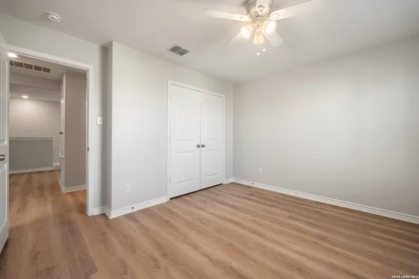 a view of an empty room with wooden floor