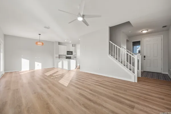 a view of a kitchen with wooden floor and a sink