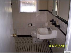 4710 Beatties Ford Road Charlotte, NC 28216 - Photo 4 of 6 a bathroom with a sink toilet and a window