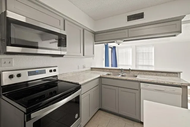 a kitchen with a stove and a microwave