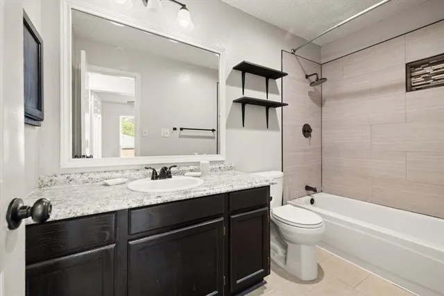 a bathroom with a sink toilet tub and shower