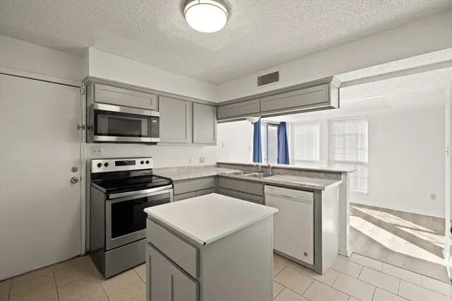 a kitchen with a stove and a microwave