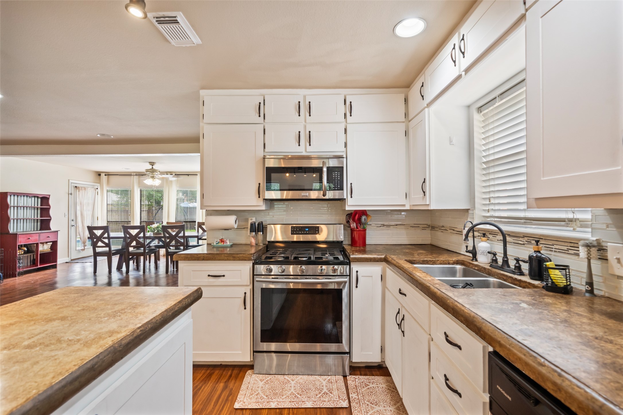 600 Hampton Hall Lane Conroe, TX 77302 - Photo 11 of 32 a kitchen with cabinets a sink and appliances