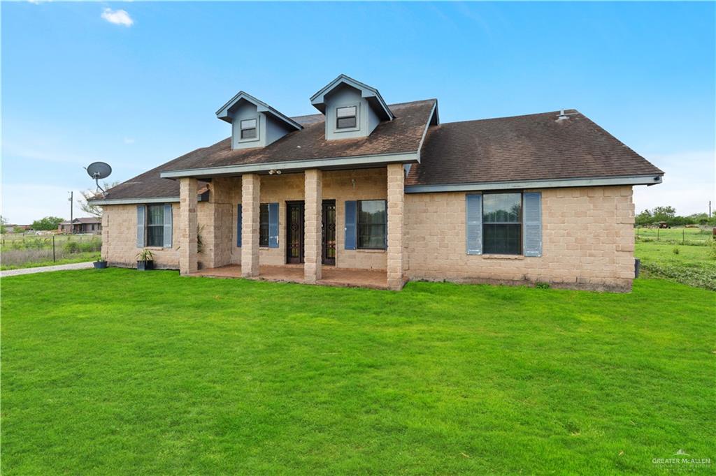 24175 Engleman Road Edcouch, TX 78538 - Photo 5 of 22 a front view of a house with a garden
