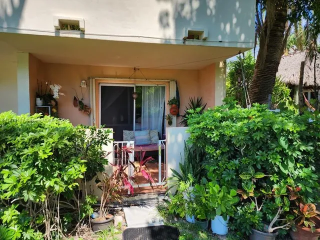 front view of a house with potted plants