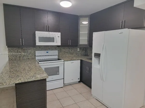 a kitchen with a stove a sink and a refrigerator