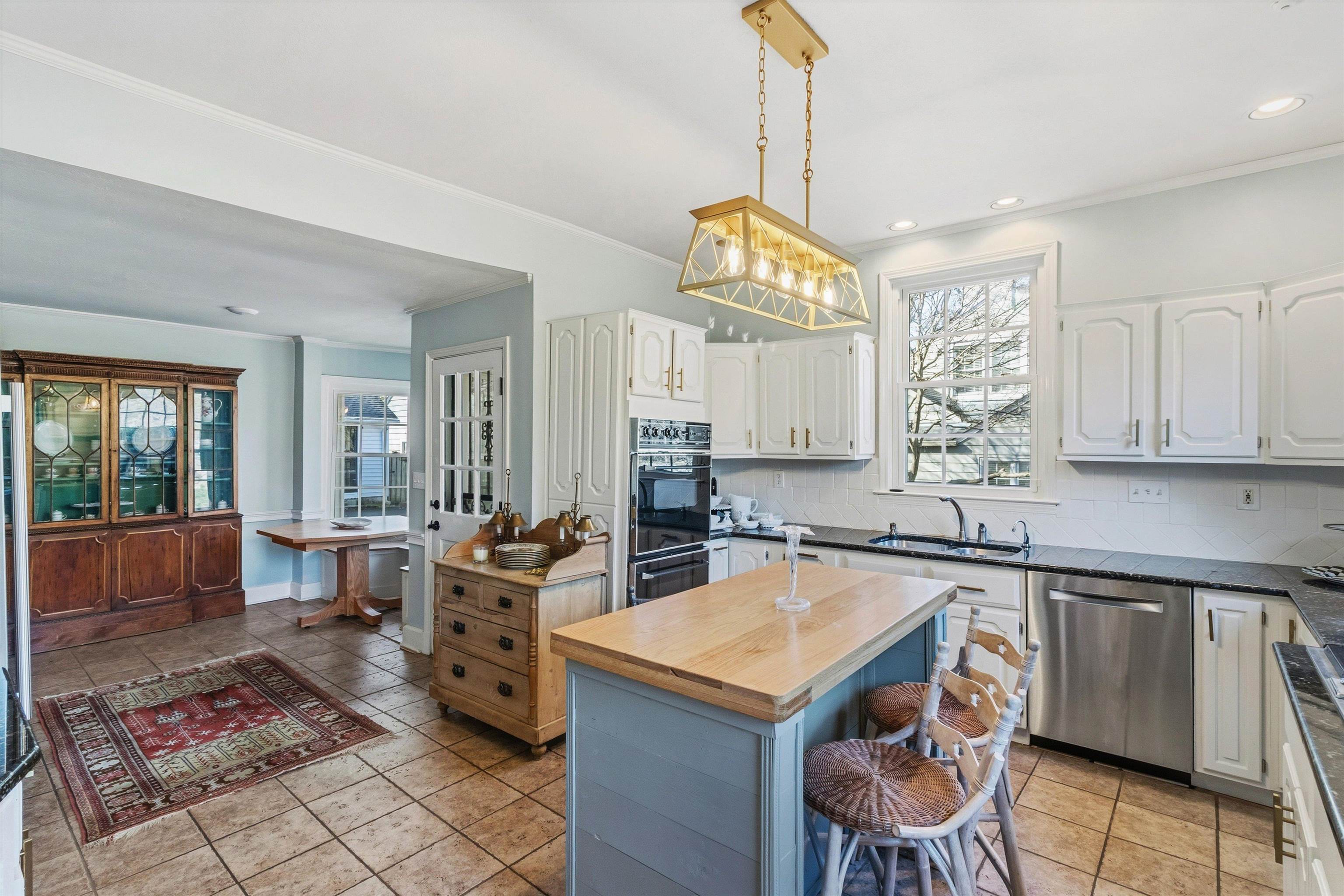 4009 Walnut Grove Road Memphis, TN 38117 - Photo 13 of 38 Kitchen with a kitchen island, decorative backsplash, wood counters, dishwasher, and ornamental molding