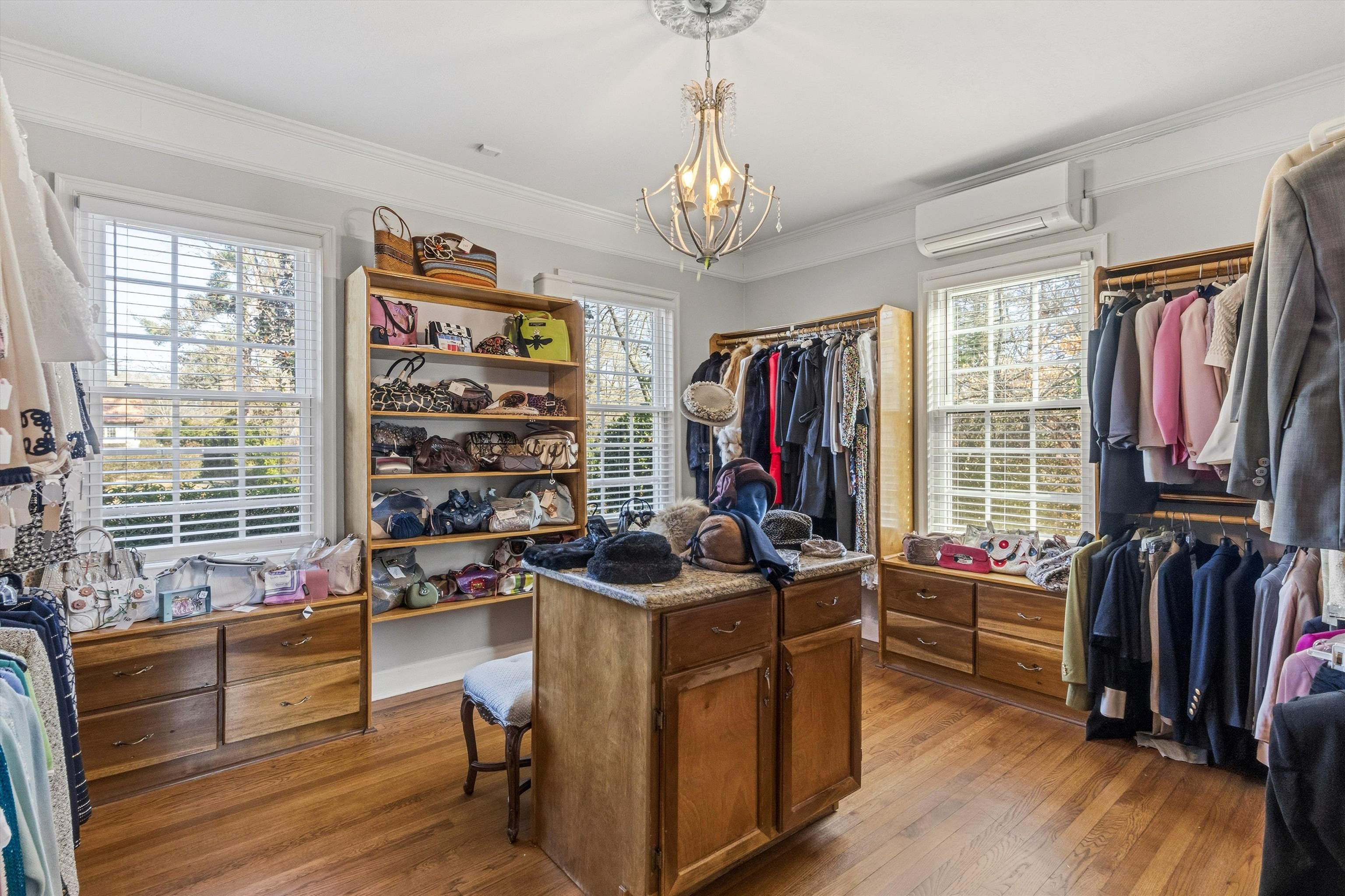 4009 Walnut Grove Road Memphis, TN 38117 - Photo 16 of 38 Spacious closet with dark wood finished floors, a wall unit AC, and a chandelier