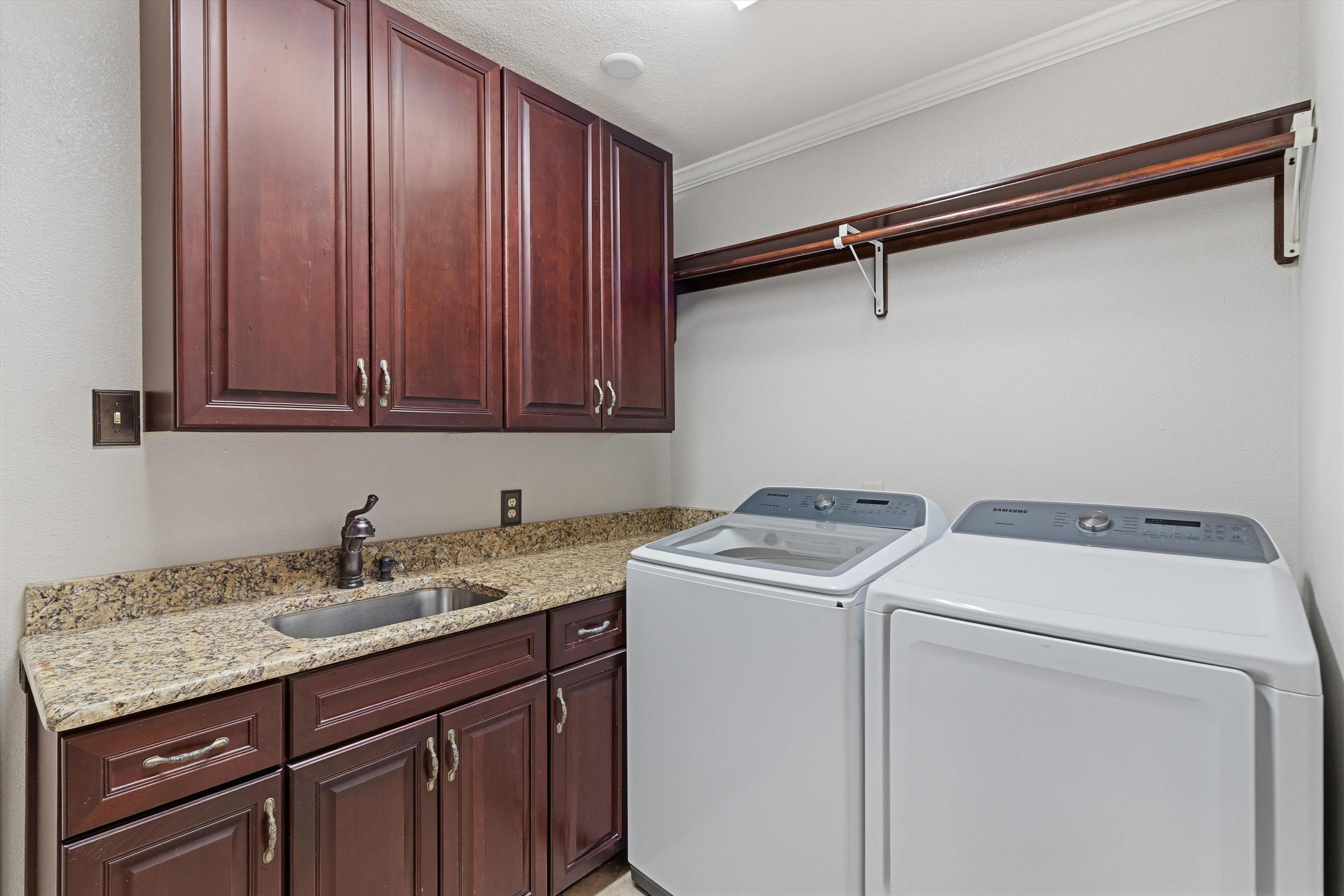 4009 Walnut Grove Road Memphis, TN 38117 - Photo 19 of 38 Laundry room featuring cabinet space, independent washer and dryer, and crown molding