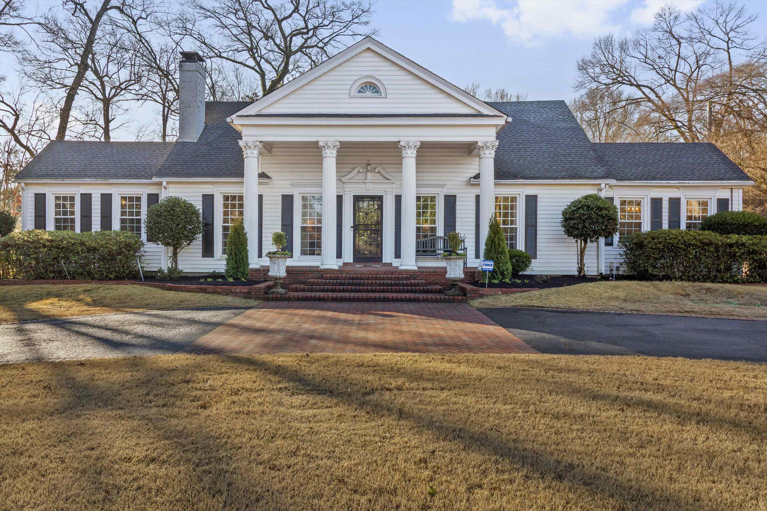 4009 Walnut Grove Road Memphis, TN 38117 - Photo 2 of 38 Neoclassical / greek revival house with covered porch, a front yard, a chimney, and roof with shingles