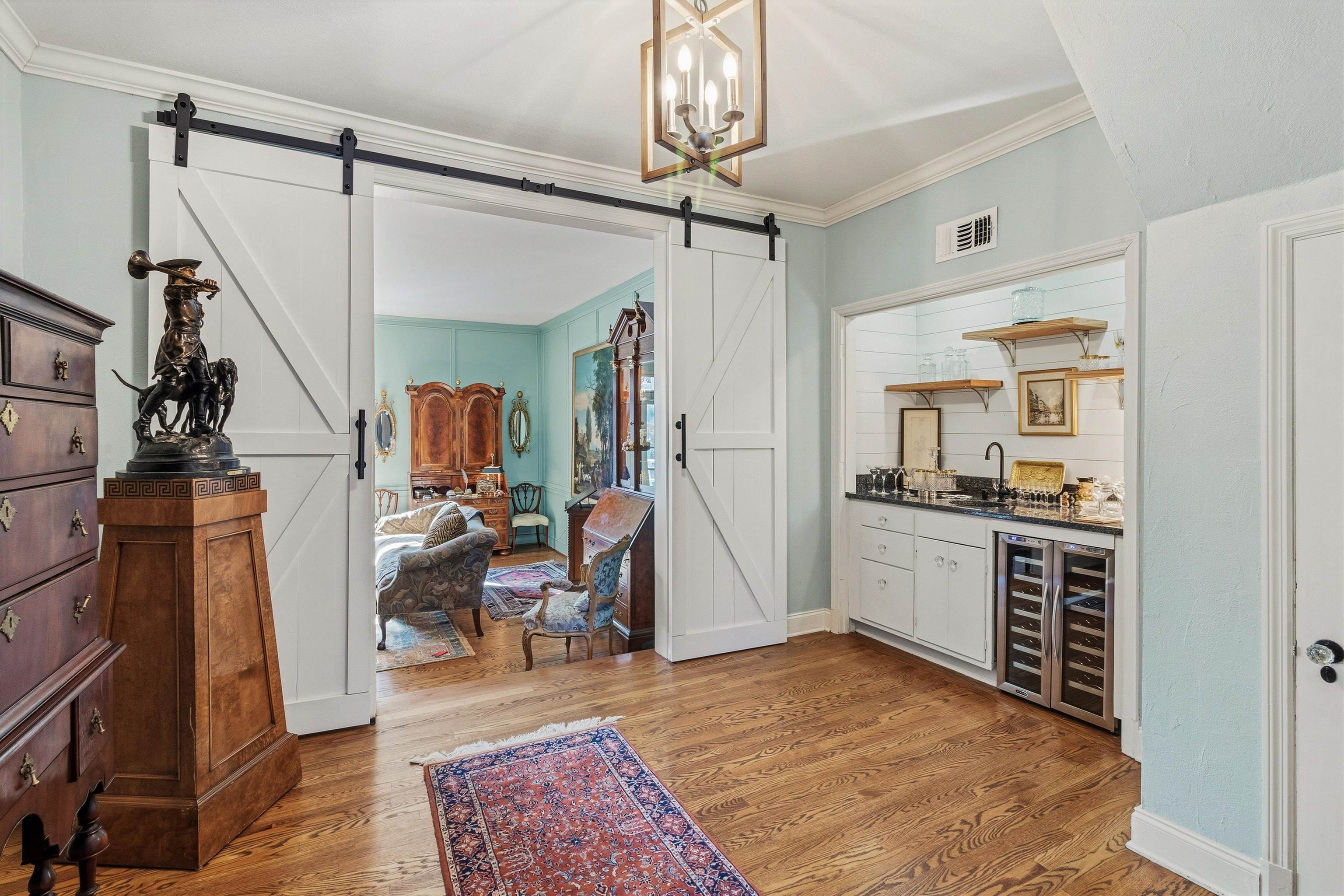 4009 Walnut Grove Road Memphis, TN 38117 - Photo 8 of 38 Indoor wet bar featuring crown molding, wine cooler, light wood-style floors, open shelves, and a barn door