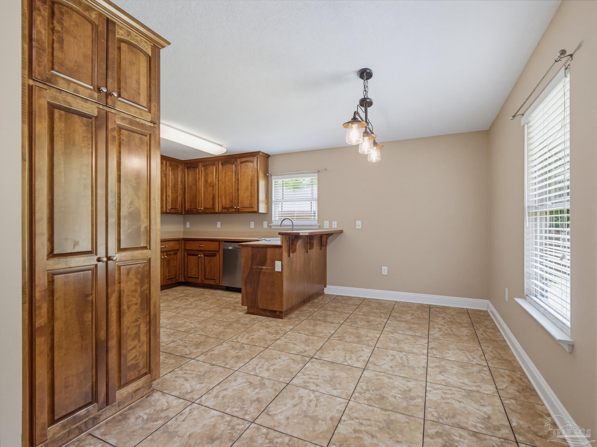 5567 Jones Street Milton, FL 32570 - Photo 12 of 48 a view of kitchen with granite countertop cabinets and refrigerator