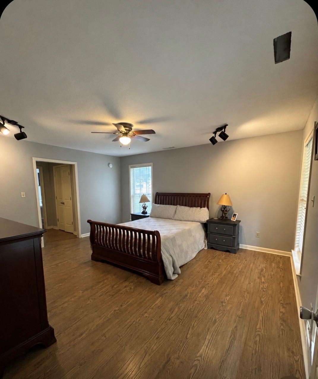 20 Pennington Road Halls, TN 38040 - Photo 15 of 27 Wood-finish flooring, ceiling fan, track lighting, and window with blinds