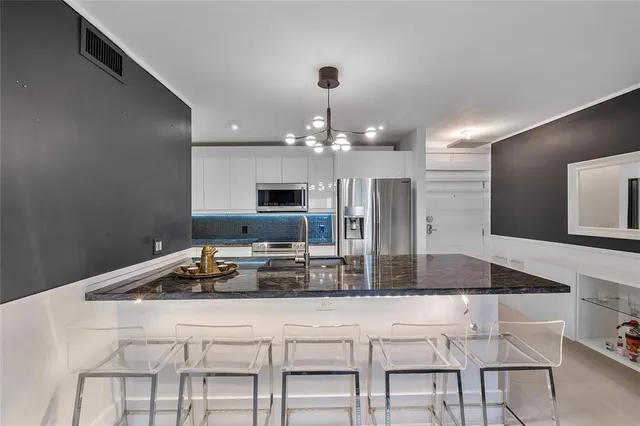 a kitchen with a kitchen island a stove and a sink
