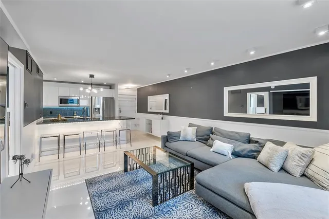 a living room with furniture and kitchen view