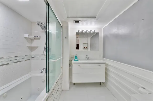 a bathroom with a bathtub sink and mirror