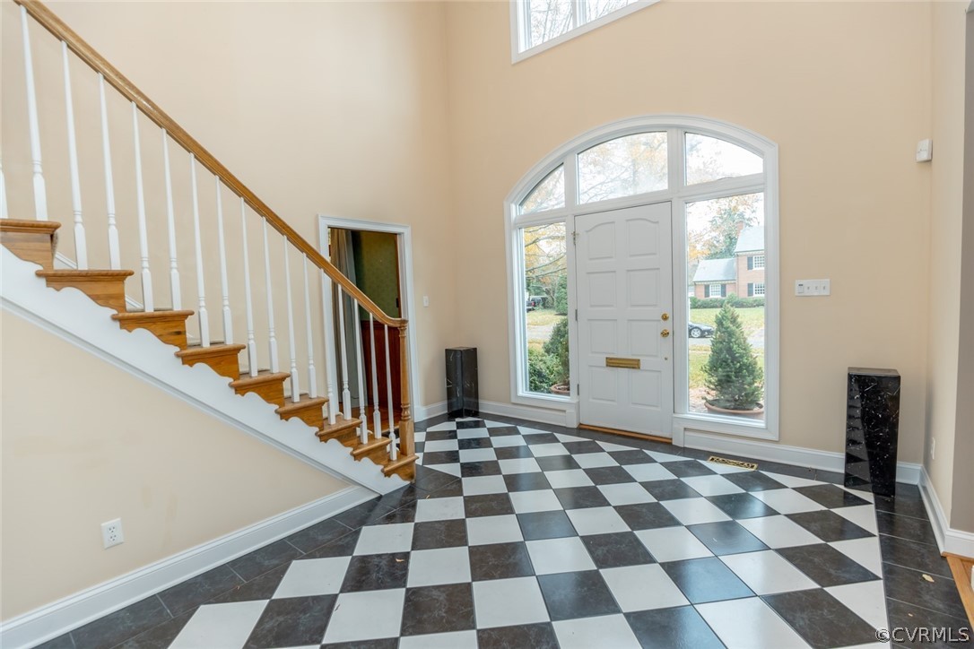 The front door opens to a grand two-story entrance