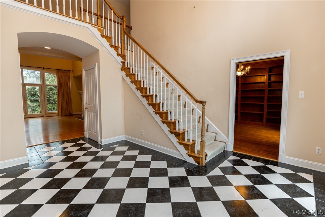 The entrance hall leads back to the formal living
