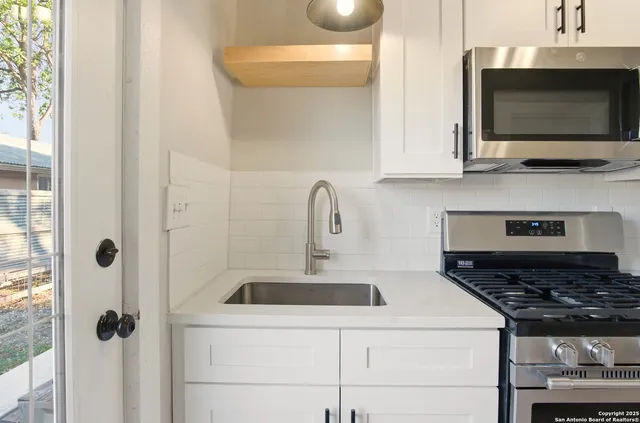a kitchen with a stove and a microwave