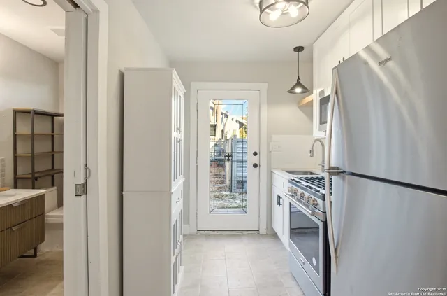 a view of kitchen with furniture and refrigerator