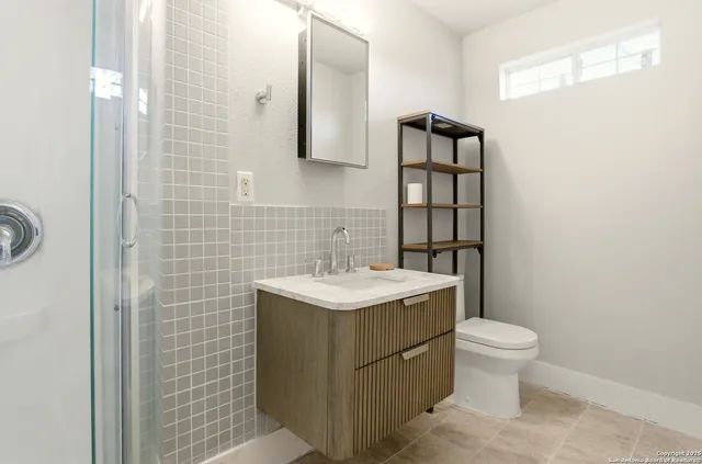 a bathroom with a sink toilet and shower