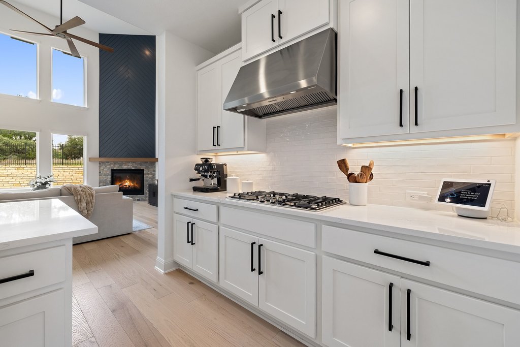 365 Pear Tree Lane Austin, TX 78737 - Photo 15 of 39 a kitchen with stainless steel appliances white cabinets and a sink