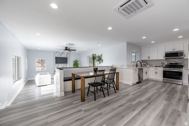 476 Spring Drive Toquerville, UT 84774 - Photo 70 of 95 Kitchen featuring stainless steel appliances, white cabinets, a peninsula, recessed lighting, and light wood finished floors
