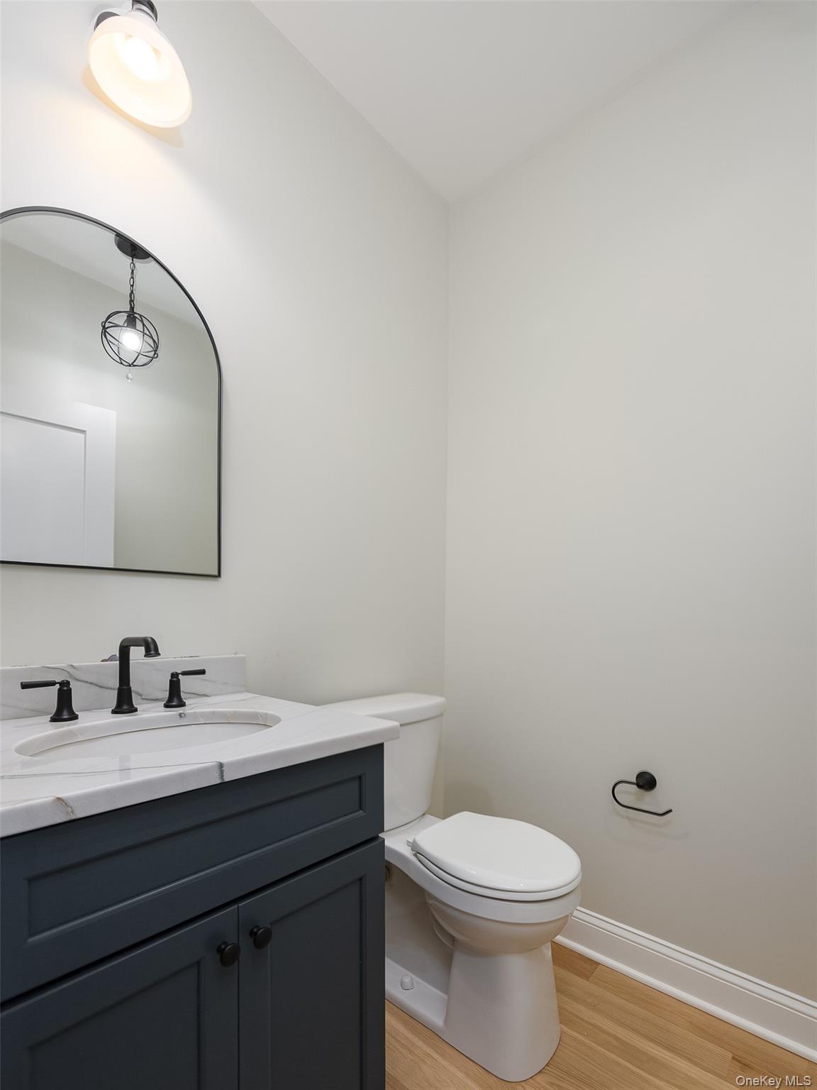 15 Henry Street, Unit 2 Beacon, NY 12508 - Photo 11 of 25 a bathroom with a toilet a sink and mirror