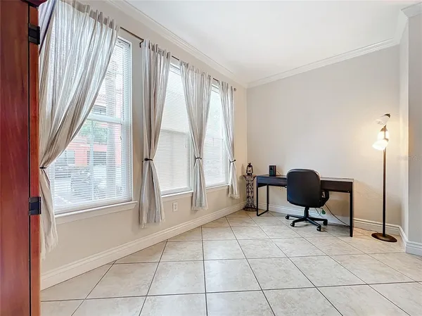 a view of a workspace with furniture and a window