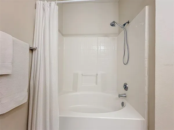 a bathroom with a bath tub and a shower