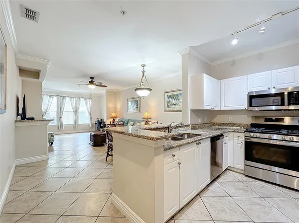 a kitchen with a stove a sink and a refrigerator