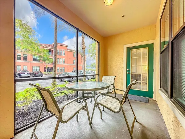 a dining room with furniture and a floor to ceiling window