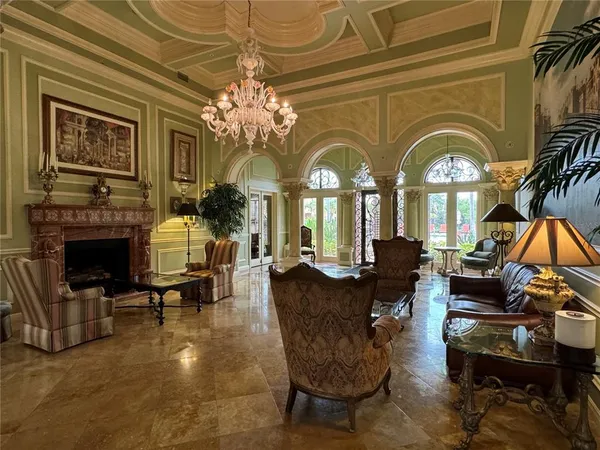 a living room with fireplace furniture and a large window
