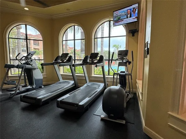 a room with gym equipment and a large window