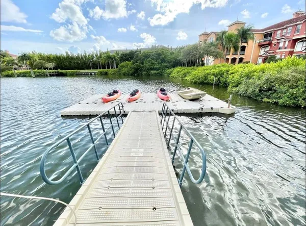 a balcony with wooden floor and lake view