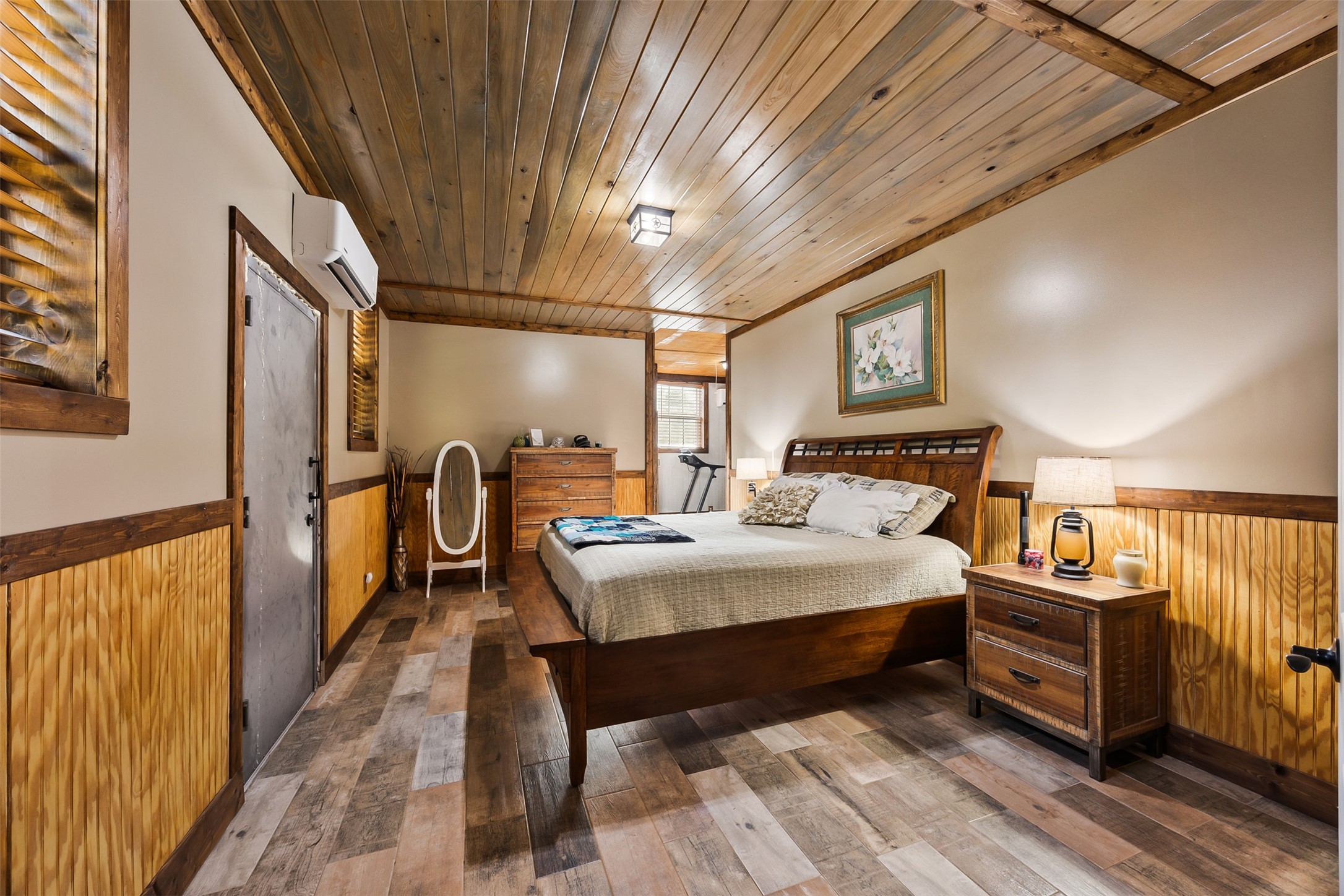 40 Olson Road New Waverly, TX 77358 - Photo 13 of 34 a very nice looking bedroom with a bed a dresser with wooden floor